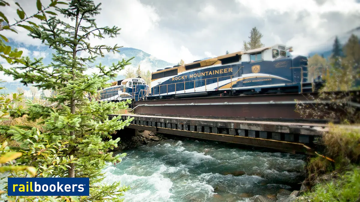 The Rocky Mountaineer train crossing a bridge over a river