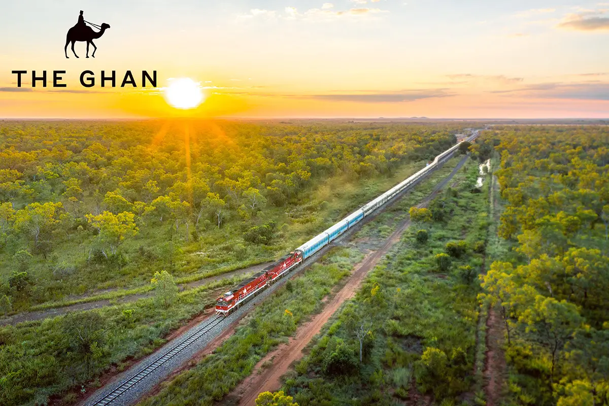 View of The Ghan train, travelling through an expanse of green