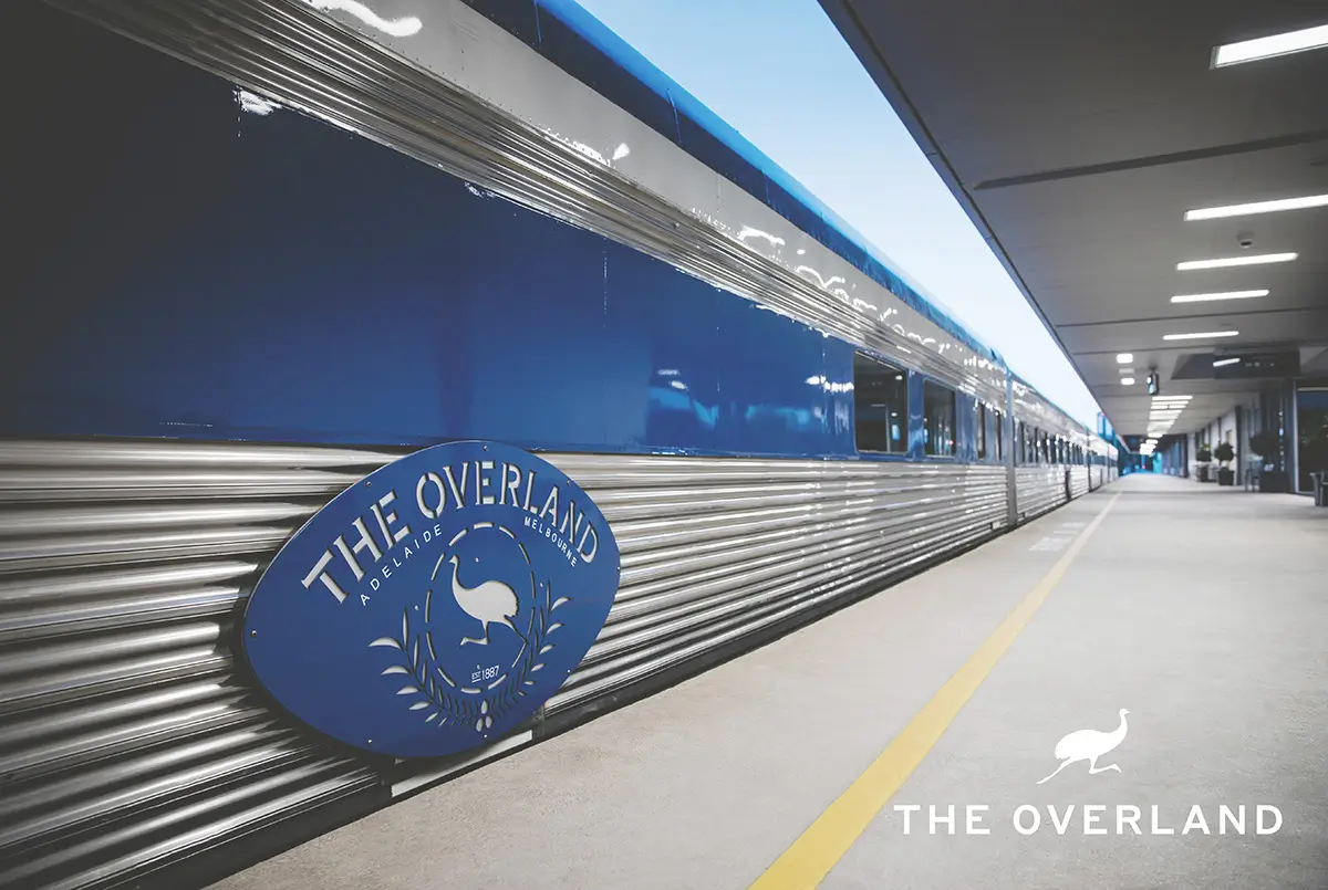 View of the side of The Overland train at a station
