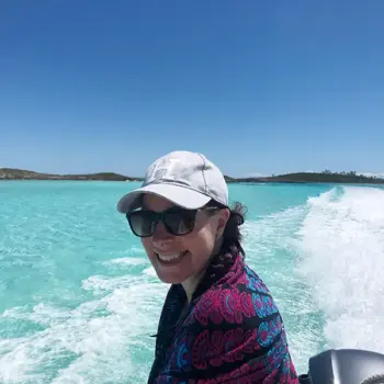 Amanda in Exuma, Bahamas Amanda in a speedboat with the pristine waters of the Bahamas behind her