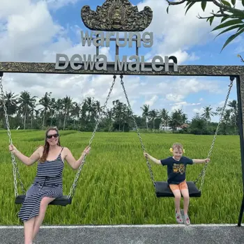 Amanda in Bali Amanda and her child sit on swings in front of a rice paddy in Bali